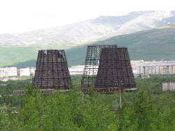 The cooling towers at Apatity with the smelter and Khibiny Mountains in the background.